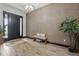 Grand foyer featuring a bench seating, dark front door and a modern light fixture at 5427 Orange Orchard Dr, Winter Garden, FL 34787