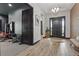Welcoming foyer featuring wood-look tile, a bench, adjacent to an at home gym at 5427 Orange Orchard Dr, Winter Garden, FL 34787