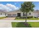 Charming single-story home featuring a brick driveway, two-car garage, and well-maintained landscaping at 5427 Orange Orchard Dr, Winter Garden, FL 34787