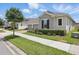 Attractive home with a two car garage, verdant lawn, trimmed shrubs and a brick paver driveway at 5427 Orange Orchard Dr, Winter Garden, FL 34787