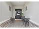Inviting front porch with decorative tile, charming seating, and stylish decor at 5427 Orange Orchard Dr, Winter Garden, FL 34787