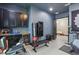 Spacious home gym with dark cabinetry, a wine cooler, and various exercise equipment for a complete workout experience at 5427 Orange Orchard Dr, Winter Garden, FL 34787