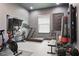 Well-equipped home gym featuring modern exercise equipment including a treadmill, exercise bike, and weightlifting station at 5427 Orange Orchard Dr, Winter Garden, FL 34787