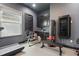 Home gym with black cabinets, a wine cooler, and a variety of fitness equipment, designed for a comprehensive workout at 5427 Orange Orchard Dr, Winter Garden, FL 34787