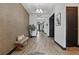 Elegant hallway featuring wood-look tile floors, modern light fixture, and decorative accents at 5427 Orange Orchard Dr, Winter Garden, FL 34787