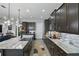 Spacious kitchen with an oversized island, granite countertops, custom cabinets, and stainless steel appliances at 5427 Orange Orchard Dr, Winter Garden, FL 34787