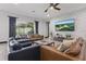 Bright and spacious living room with two couches, a stone accent wall and great backyard views at 5427 Orange Orchard Dr, Winter Garden, FL 34787