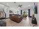 Spacious living room with stylish furnishings, tile floors, and natural light from sliding glass door at 5427 Orange Orchard Dr, Winter Garden, FL 34787