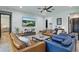 Bright living room featuring stylish furniture, modern decor, and a textured accent wall with a large screen TV at 5427 Orange Orchard Dr, Winter Garden, FL 34787