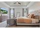 A spacious main bedroom boasts a decorative ceiling, neutral tones, and plenty of natural light at 5427 Orange Orchard Dr, Winter Garden, FL 34787