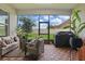 Relaxing screened-in patio with ample seating overlooking the backyard and lush greenery at 5427 Orange Orchard Dr, Winter Garden, FL 34787
