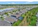 Aerial view of a residential neighborhood featuring single-Gathering homes, lush landscaping, and a serene pond at 553 Adenmore Ter, Deland, FL 32724