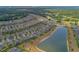Panoramic aerial shot of a residential area with a pond, highlighting the community's serene environment at 553 Adenmore Ter, Deland, FL 32724