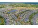 Wide aerial shot showcases community homes bordering a pond and golf course at 553 Adenmore Ter, Deland, FL 32724