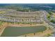 Expansive aerial view of a residential community featuring a scenic pond and lush landscaping at 553 Adenmore Ter, Deland, FL 32724