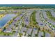 Vast aerial view of single-Gathering homes with pristine landscaping, a lake, and mature trees at 553 Adenmore Ter, Deland, FL 32724