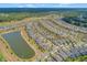 Scenic aerial view of homes in a community with a pond, showcasing the neighborhood's layout at 553 Adenmore Ter, Deland, FL 32724