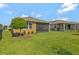 Beautiful backyard with green lawn and landscaping, partially fenced at 553 Adenmore Ter, Deland, FL 32724