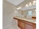 A bathroom features a marble countertop vanity and a large mirror with sconces at 553 Adenmore Ter, Deland, FL 32724