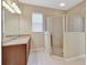 The bathroom features a glass enclosed shower, light tile and light walls at 553 Adenmore Ter, Deland, FL 32724