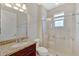 Bathroom features granite vanity, framed mirror, glass shower, and decorative window at 553 Adenmore Ter, Deland, FL 32724