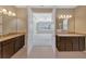 A primary bathroom with dual vanities leads to a bedroom at 553 Adenmore Ter, Deland, FL 32724