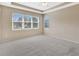 A spacious bedroom features neutral-toned carpet and lots of natural light at 553 Adenmore Ter, Deland, FL 32724