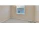 Carpeted bedroom with neutral walls, a window with blinds, and a ceiling fan at 553 Adenmore Ter, Deland, FL 32724