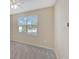 A simple bedroom featuring neutral walls, carpet, and a window with blinds at 553 Adenmore Ter, Deland, FL 32724