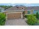 Inviting single-Gathering home with a brick driveway, two-car garage, and manicured landscaping at 553 Adenmore Ter, Deland, FL 32724
