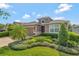 Inviting home exterior with a lush, landscaped front yard and a paver driveway at 553 Adenmore Ter, Deland, FL 32724