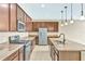 A spacious kitchen showcases granite countertops, dark cabinetry, stainless steel appliances and a central island at 553 Adenmore Ter, Deland, FL 32724