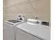 Well-equipped laundry room with a modern, white, side-by-side washer and dryer at 553 Adenmore Ter, Deland, FL 32724