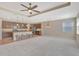 An open-concept living room showcases a granite countertop kitchen island and bar stool seating at 553 Adenmore Ter, Deland, FL 32724
