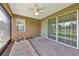 Inviting screened patio featuring brick pavers, ceiling fan and view of backyard at 553 Adenmore Ter, Deland, FL 32724