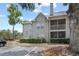 Condominium exterior featuring private balcony, and well-maintained landscaping at 6100 Westgate Dr # 101, Orlando, FL 32835