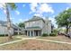 Inviting two-story condo showcasing a walkway, manicured landscaping, and convenient parking at 6100 Westgate Dr # 101, Orlando, FL 32835