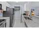Bright kitchen with stainless appliances, granite counters, and ample cabinet space at 6100 Westgate Dr # 101, Orlando, FL 32835
