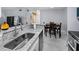 Modern kitchen with stainless steel appliances, granite countertops and a view into the living room at 6100 Westgate Dr # 101, Orlando, FL 32835
