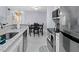 Modern kitchen with stainless steel appliances, white cabinets and a view into the dining area at 6100 Westgate Dr # 101, Orlando, FL 32835