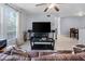 Open living room featuring a ceiling fan, TV, and tile flooring, seamlessly flowing to a dining area at 6100 Westgate Dr # 101, Orlando, FL 32835