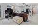 Living room with tile flooring, a ceiling fan, and an office area, offering a versatile living space at 6100 Westgate Dr # 101, Orlando, FL 32835