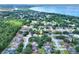Lovely aerial view showcasing homes in a quiet neighborhood near a picturesque lake at 618 Meadow Park Dr, Minneola, FL 34715