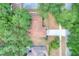 Aerial view of the house, roof, driveway, and surrounding trees at 618 Meadow Park Dr, Minneola, FL 34715
