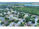 Aerial view of neighborhood showcasing homes, trees, nearby lake and surrounding area at 618 Meadow Park Dr, Minneola, FL 34715