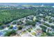 Expansive aerial view of a residential area featuring tree-lined streets and well-maintained homes in a serene community setting at 618 Meadow Park Dr, Minneola, FL 34715