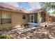 View of backyard featuring mature landscaping, stone pavers, and a screened in porch at 618 Meadow Park Dr, Minneola, FL 34715