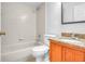 Bathroom with granite vanity, neutral tile, and shower over bath at 618 Meadow Park Dr, Minneola, FL 34715
