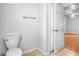 Bathroom with tiled floors, toilet, towel rack and entrance to another room at 618 Meadow Park Dr, Minneola, FL 34715