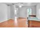 Bedroom with hardwood floors, ceiling fan, and a window letting in natural light at 618 Meadow Park Dr, Minneola, FL 34715